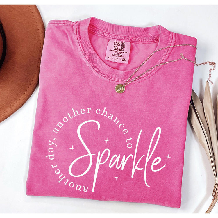 Pink Comfort Colors t-shirt with inspirational quote “another day another chance to sparkle” in white script lettering.