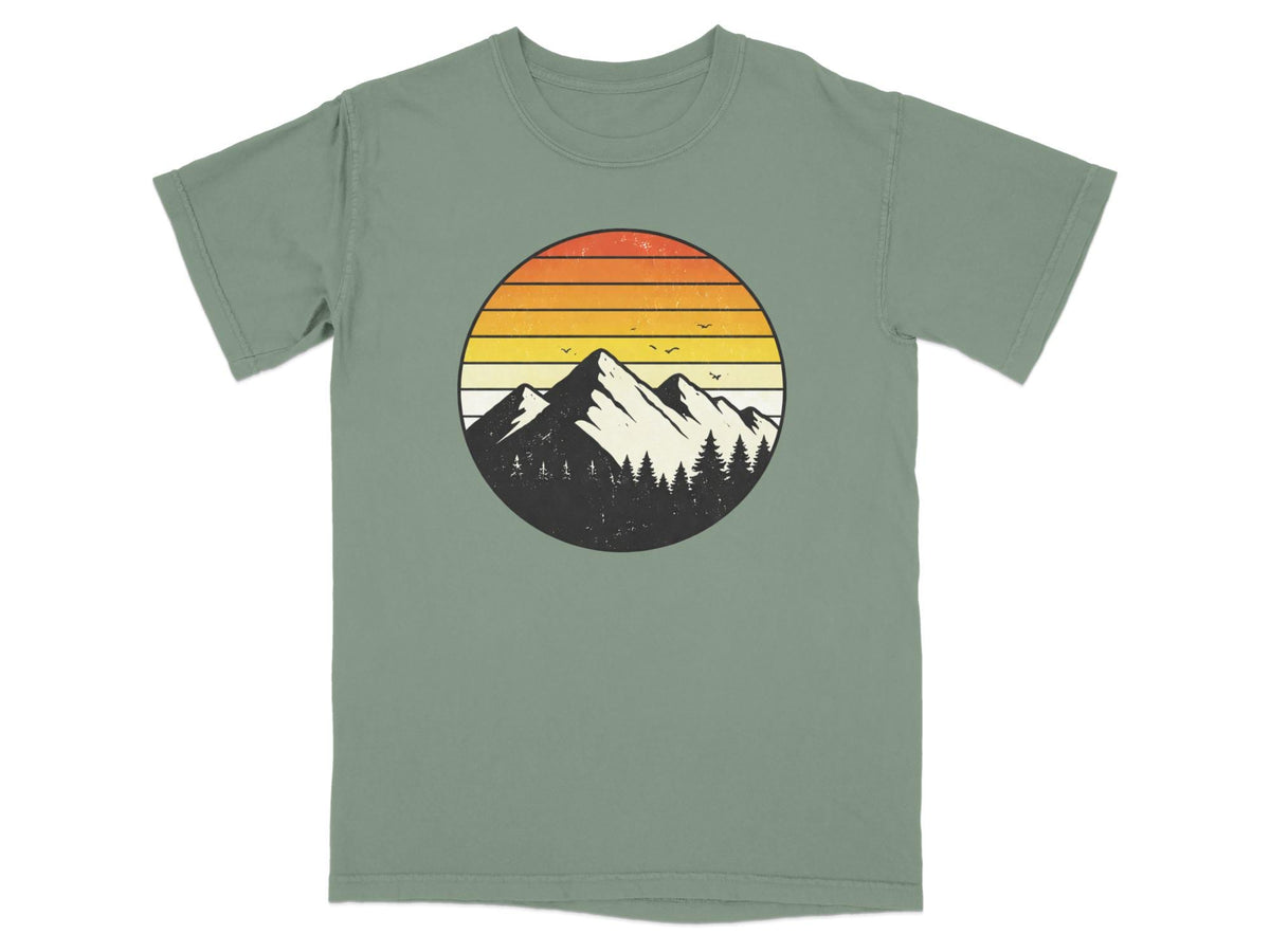 Circular graphic of mountains and trees with a striped sunset.