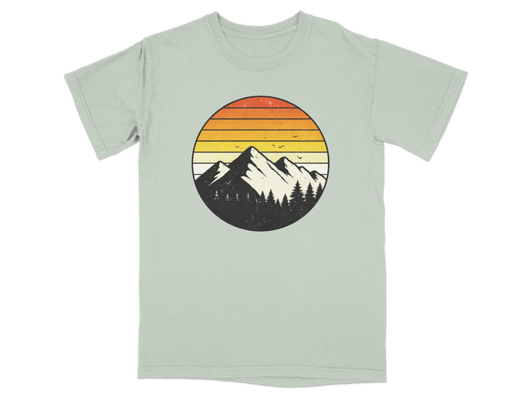 T-shirt with a circular graphic of mountains, trees, and a sunset.