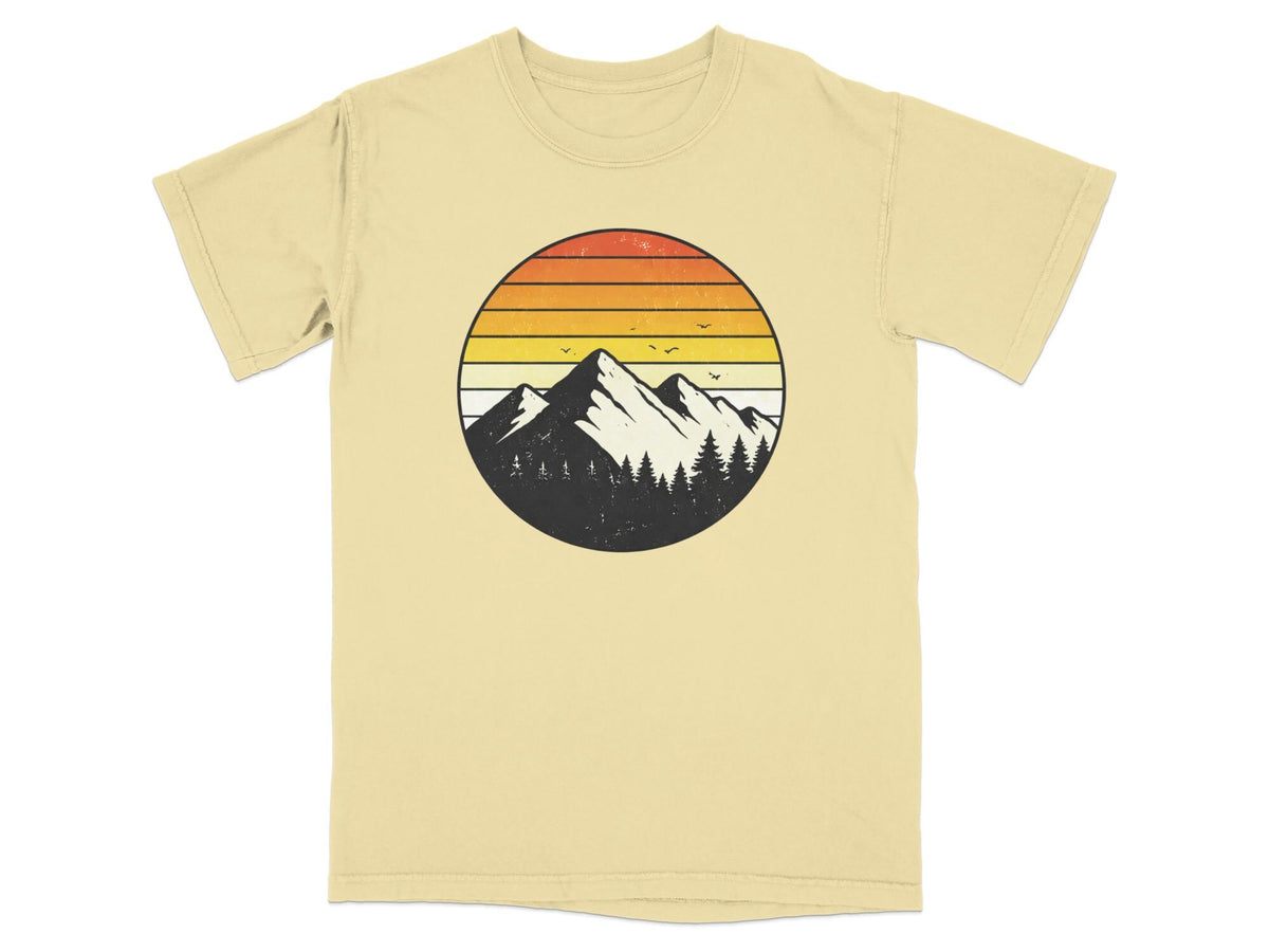 Circular retro mountain sunset graphic on a light yellow t-shirt.