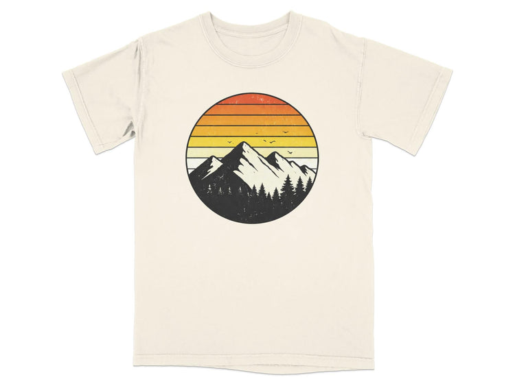 Cream t-shirt with a circular graphic of mountains, trees, and a sunset.