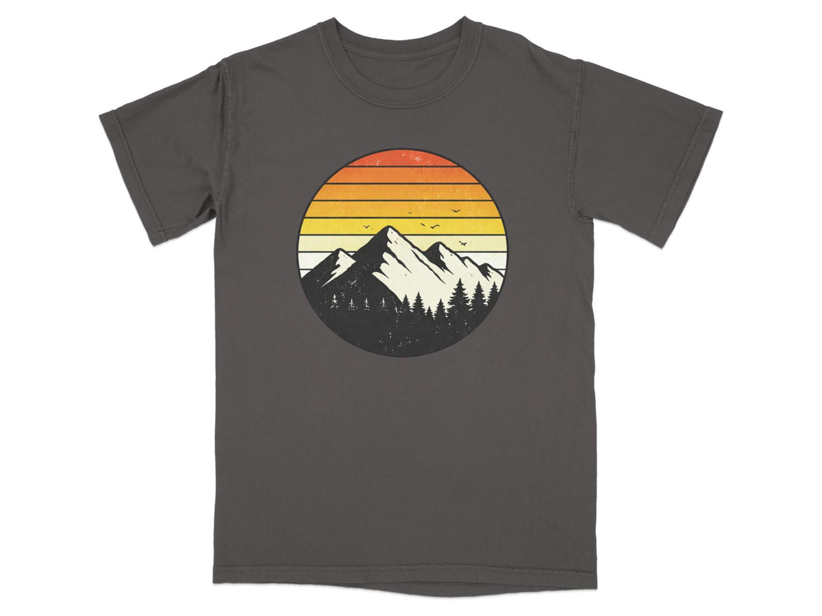 Graphic t-shirt with a circular mountain and sunset design.