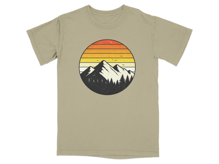 Circular graphic of mountains and trees with sunset colors.