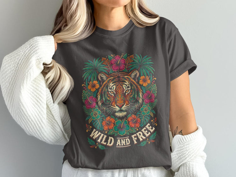 Tiger with colorful flowers and text "WILD AND FREE" on a dark grey t-shirt.