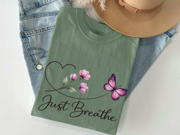 Green t-shirt with "Just Breathe" text and floral butterfly design.
