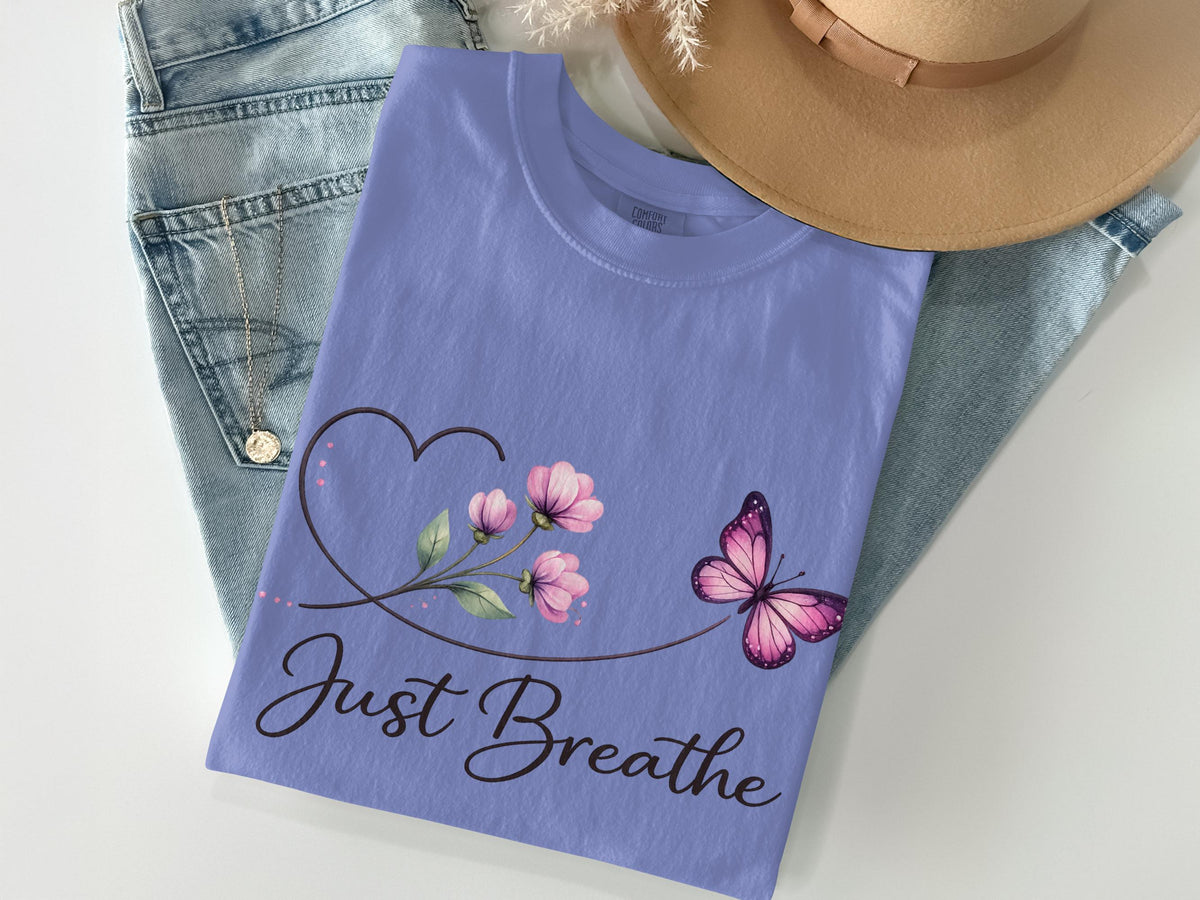 Purple t-shirt with floral heart, butterfly, and "Just Breathe" text.