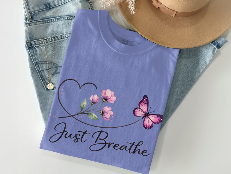 Purple t-shirt with floral heart, butterfly, and "Just Breathe" text.