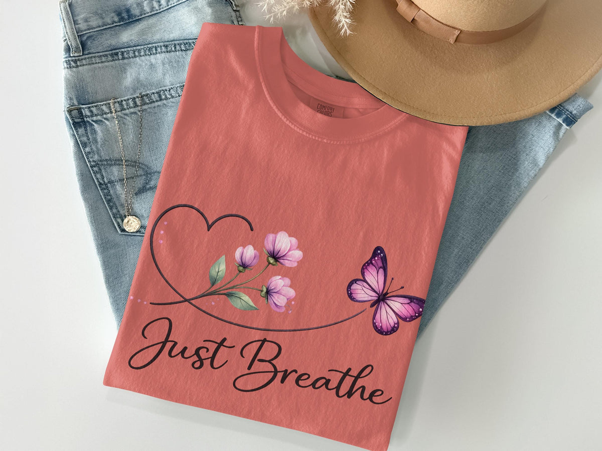 Coral t-shirt with heart, flowers, butterfly, and "Just Breathe" text.
