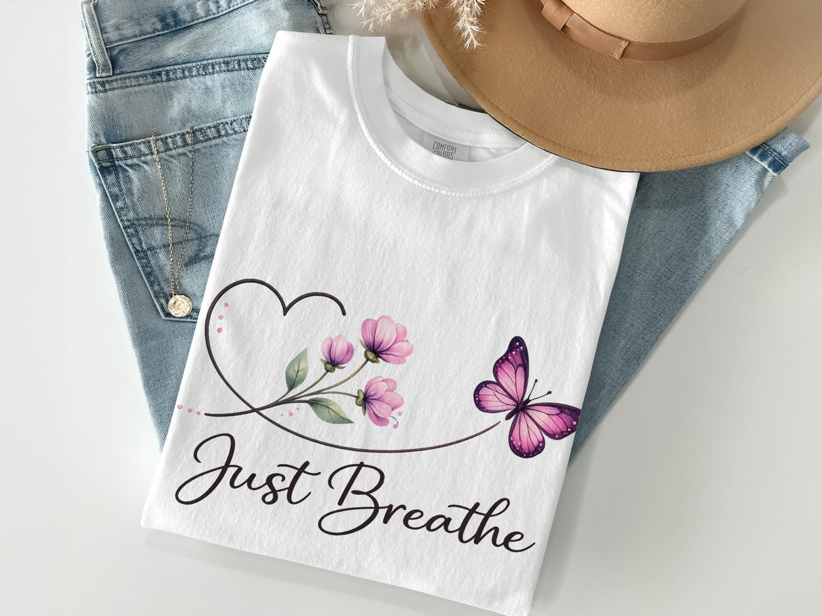 White t-shirt with "Just Breathe" text, floral design, and pink butterfly.