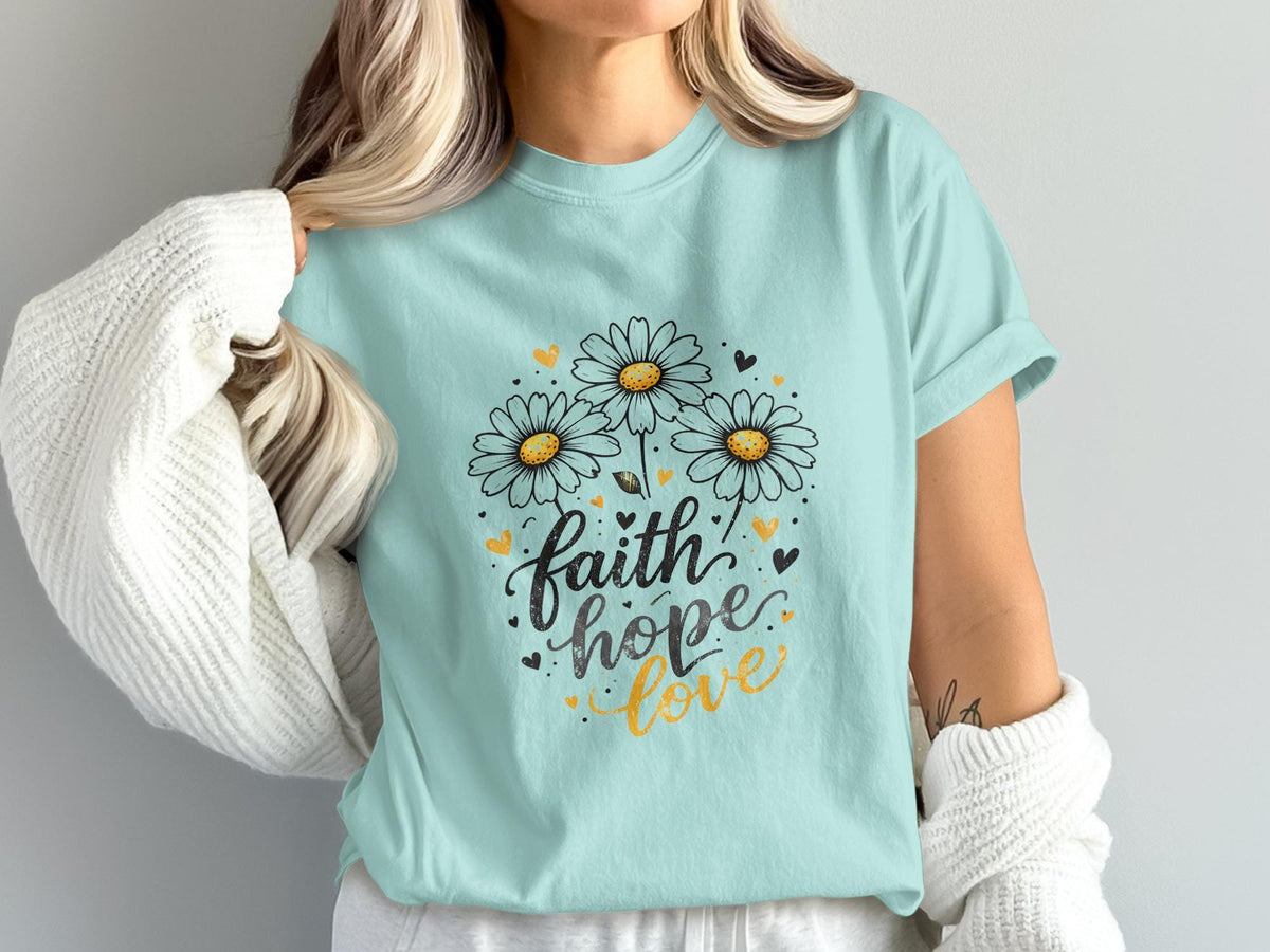 Light blue t-shirt with "faith hope love" text and three daisies.