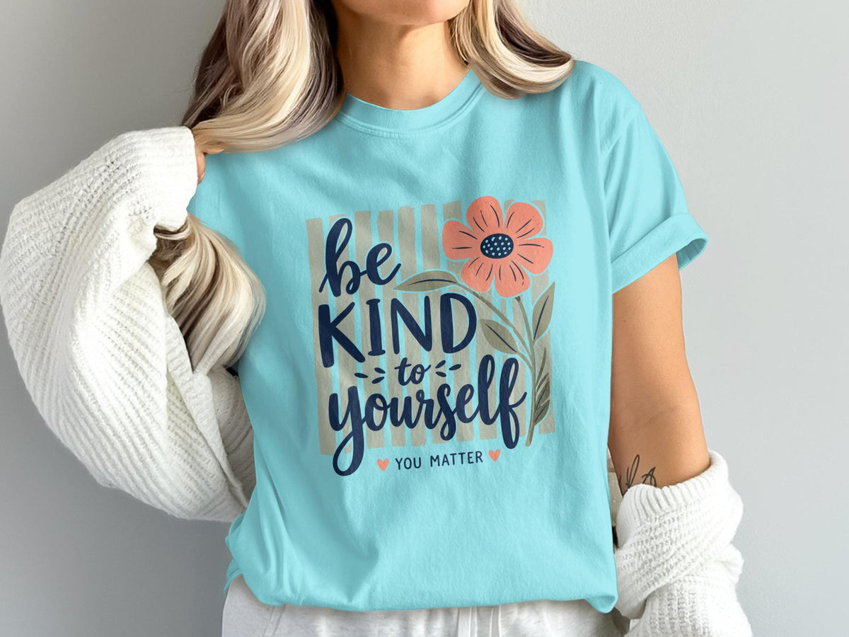 Light blue t-shirt with floral design and "Be Kind To Yourself" text.
