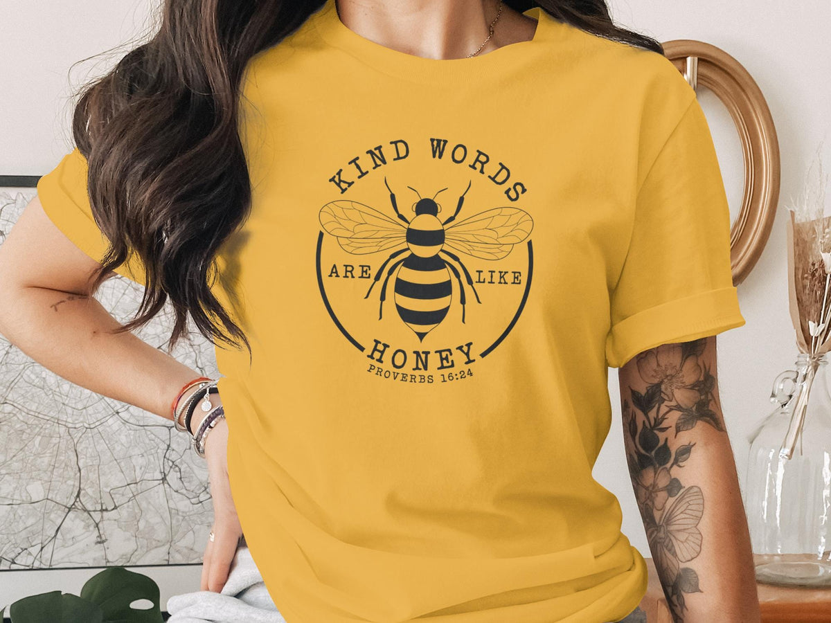 Yellow t-shirt with bee graphic and text "Kind words are honey Proverbs 16:24".