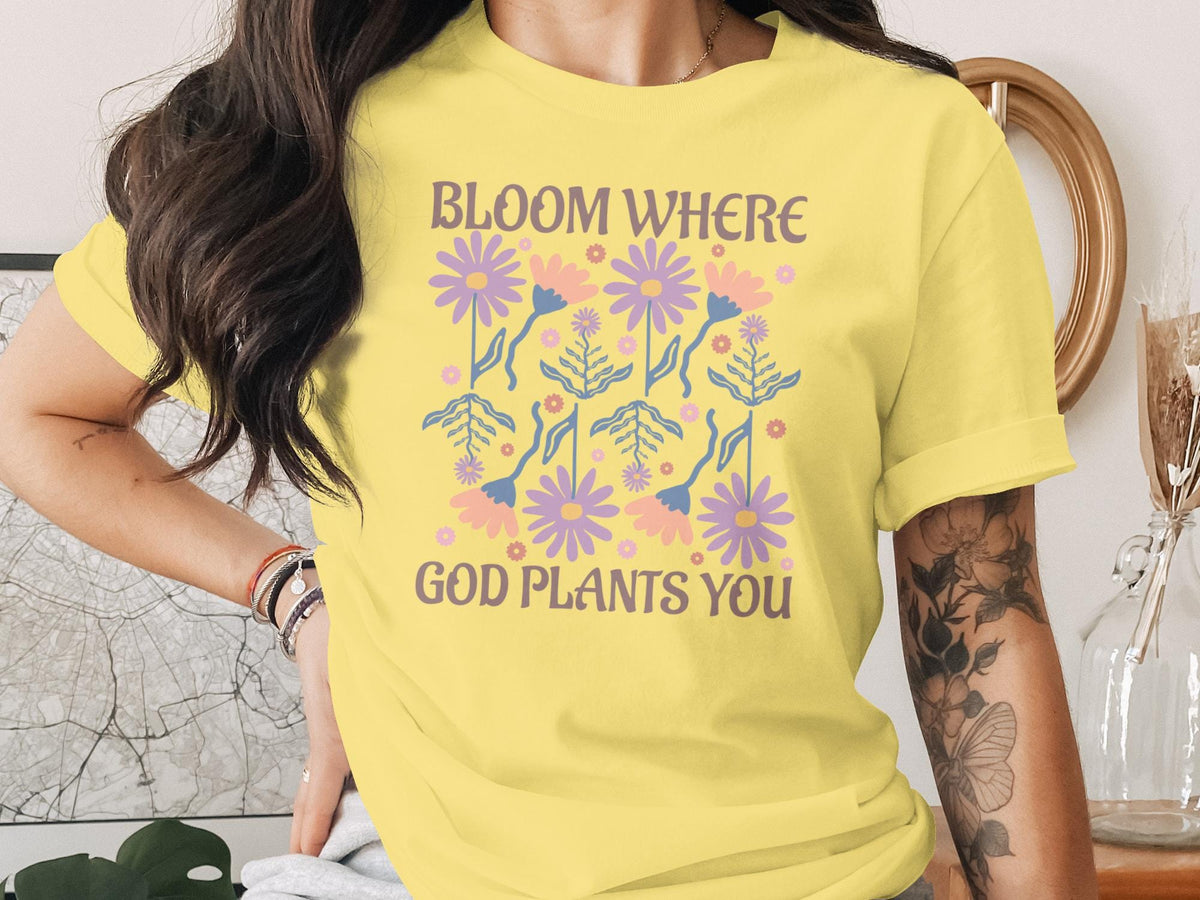 Yellow t-shirt with floral pattern and "Bloom Where God Plants You" text.
