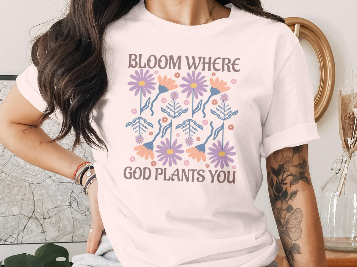 T-shirt with floral pattern and text "Bloom where God plants you".