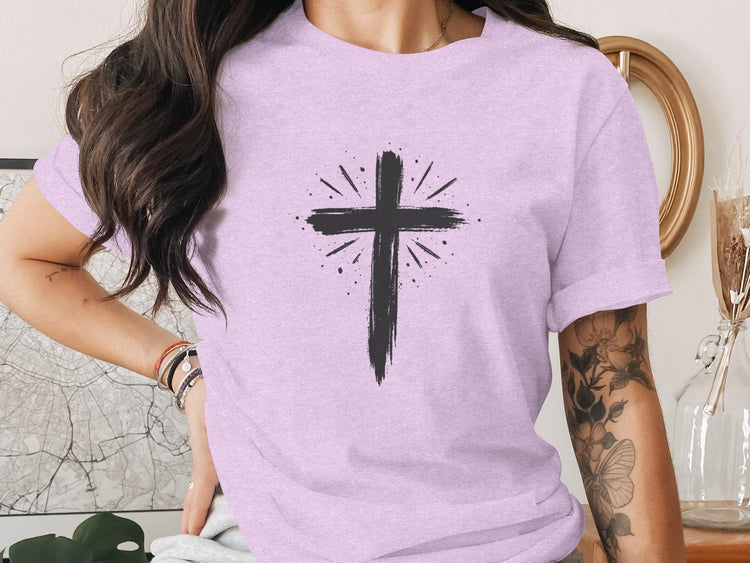 Lavender t-shirt with distressed black cross and radiating lines graphic.
