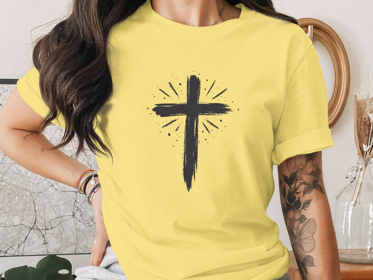 Yellow t-shirt with a black distressed cross graphic with radiating lines.
