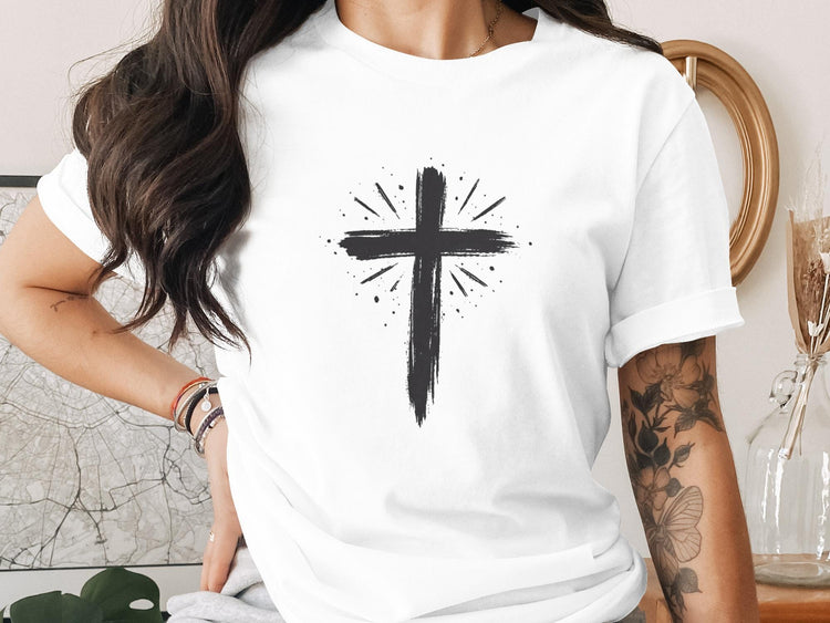 White t-shirt with a black hand-painted cross graphic and radiating lines.