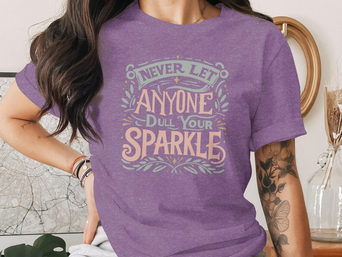 Purple t-shirt with text "Never let anyone dull your sparkle".