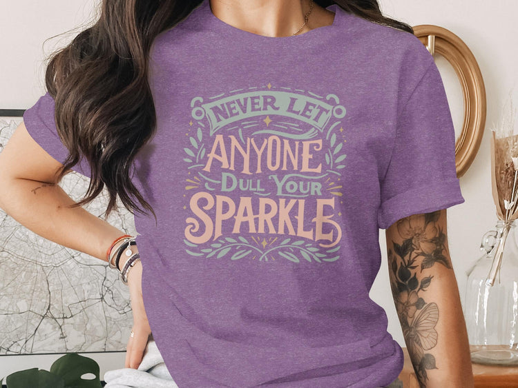 Purple t-shirt with text "Never let anyone dull your sparkle".