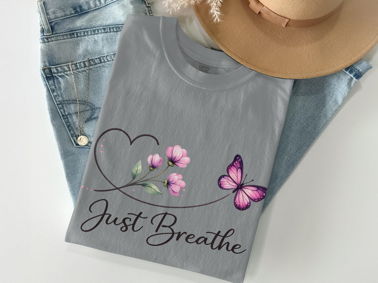 Gray t-shirt with butterfly and floral graphic and "Just Breathe" text.