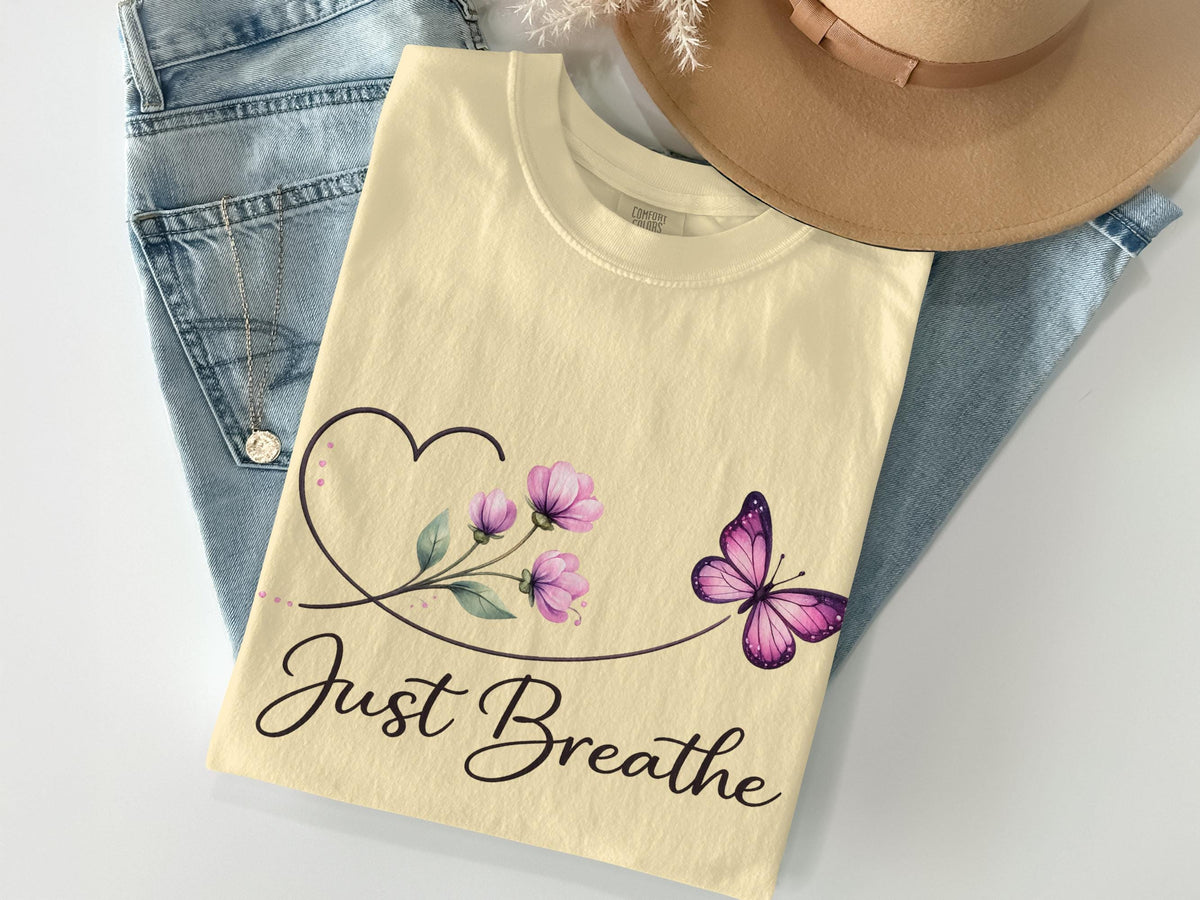 Cream t-shirt with "Just Breathe" text, heart, and purple butterfly.