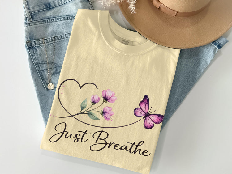 Cream t-shirt with "Just Breathe" text, heart, and purple butterfly.
