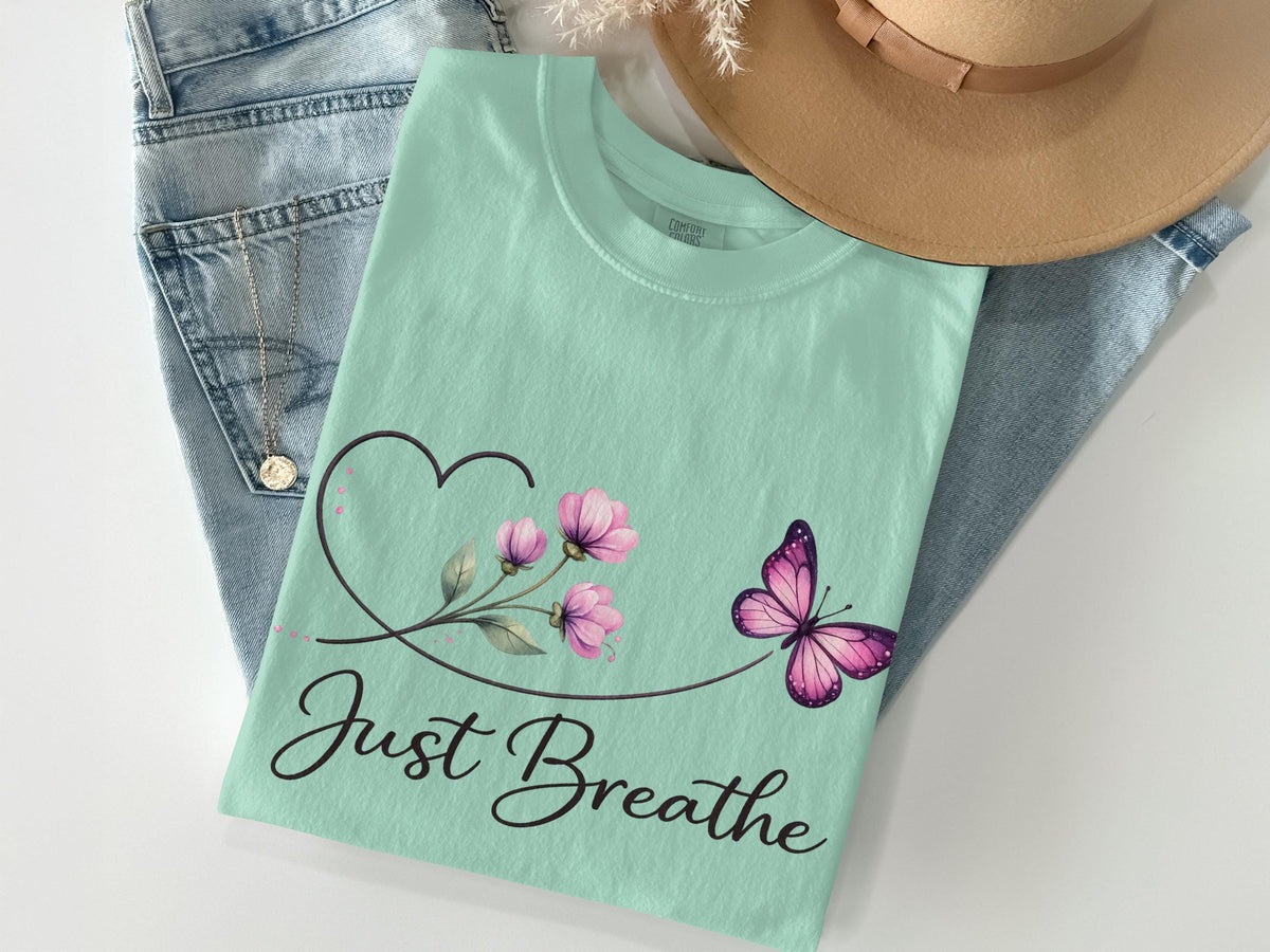 Mint green t-shirt with butterfly and flower graphic, "Just Breathe" text.