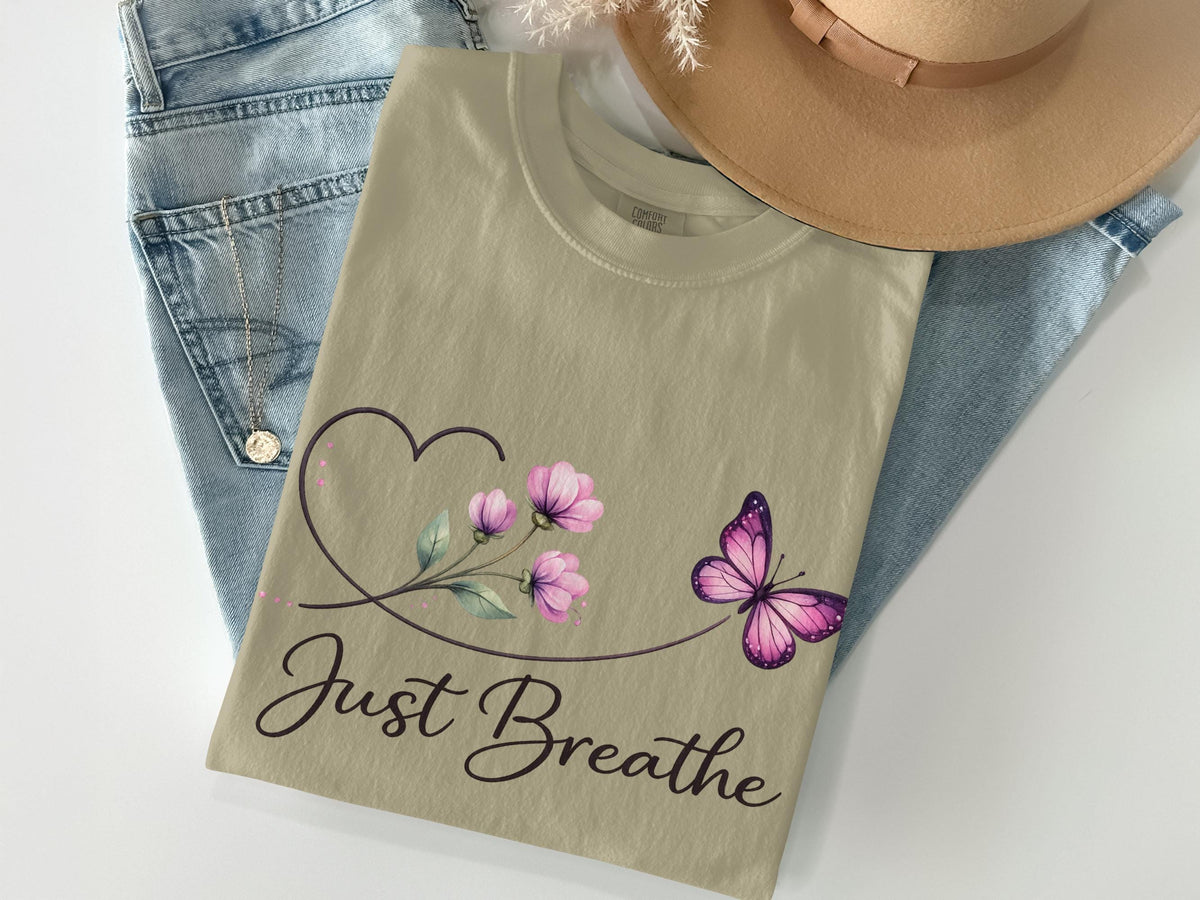 Tan t-shirt with purple butterfly, flowers, and "Just Breathe" text.
