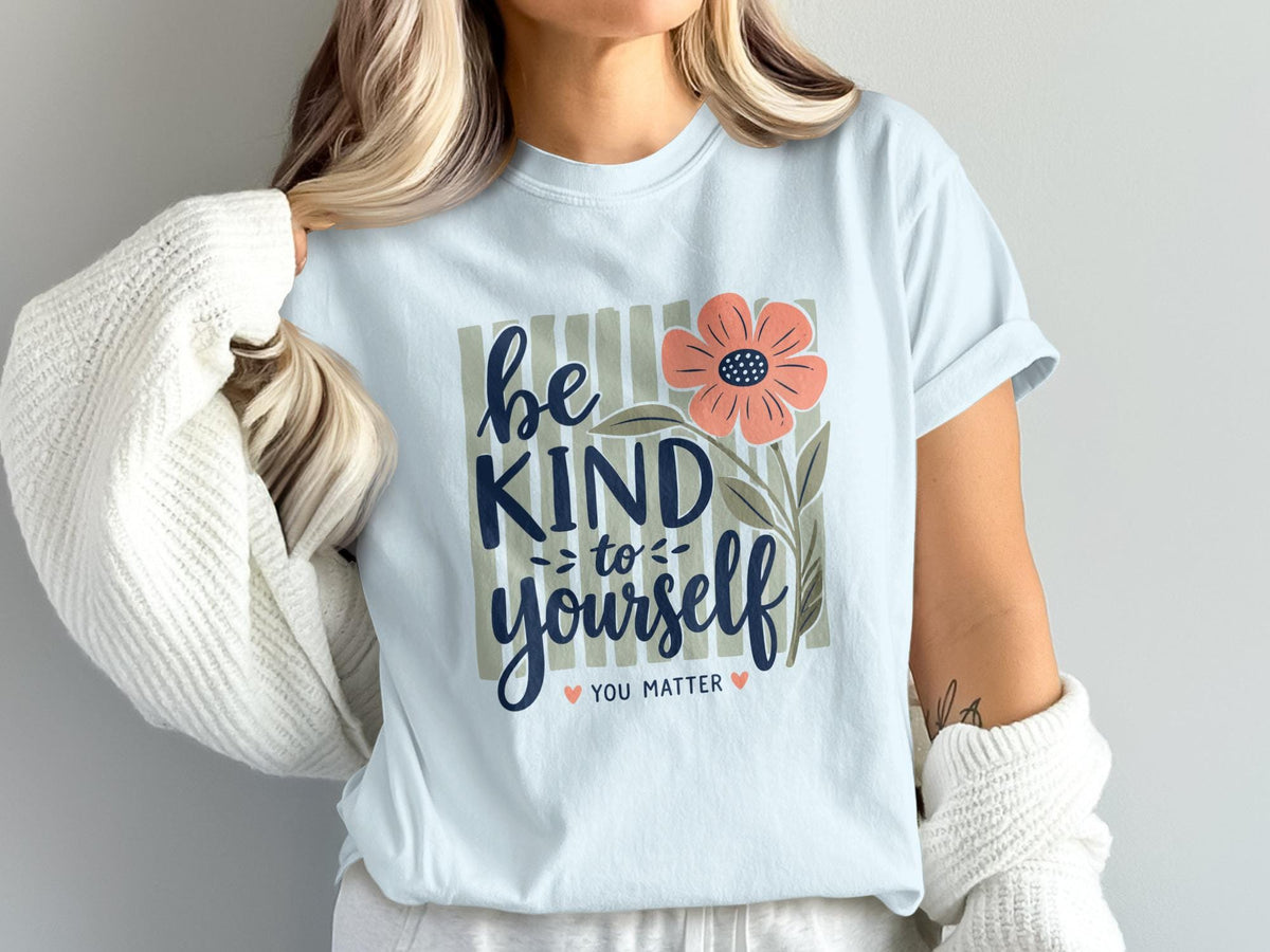 Light blue t-shirt with flower and "be kind to yourself you matter" text.