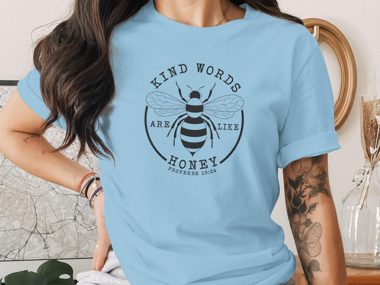 Light blue t-shirt with a black bee design and "Kind words are like honey" text.