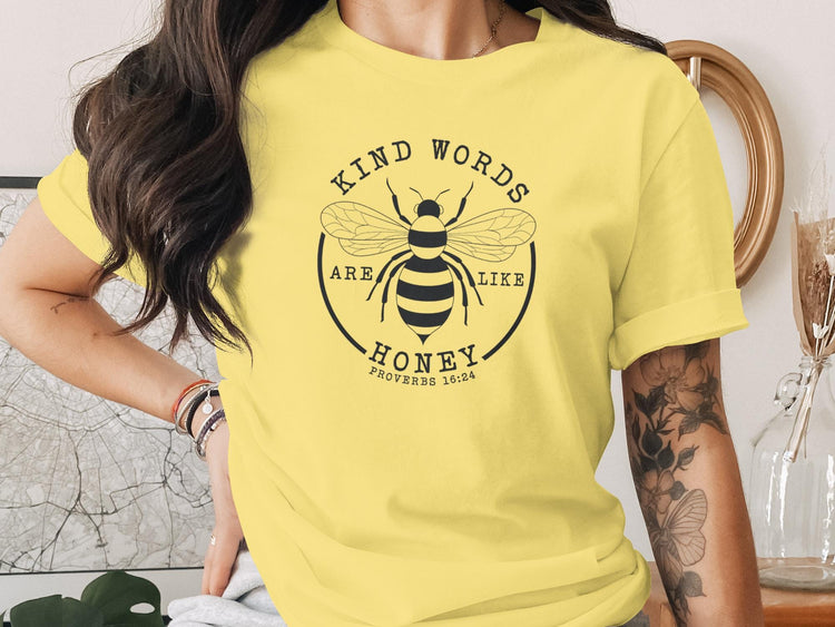 Yellow t-shirt with a bee graphic and text "Kind words are like honey" Proverbs 16:24.