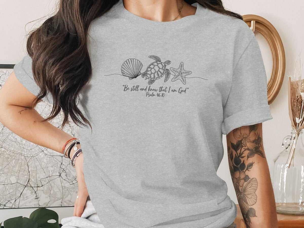 Grey t-shirt with seashells, starfish, and scripture.