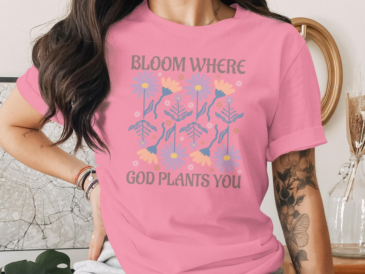 Pink t-shirt with a floral design and text "Bloom Where God Plants You".