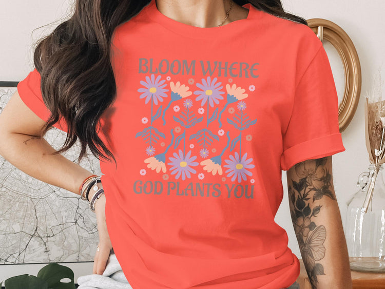 Coral t-shirt with "Bloom Where God Plants You" floral graphic.