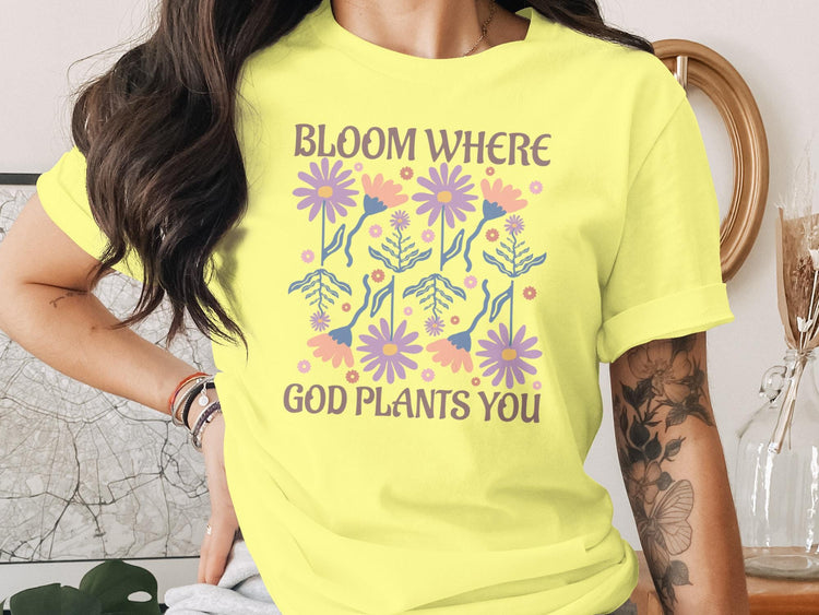 Yellow t-shirt with floral design and "Bloom Where God Plants You" text.