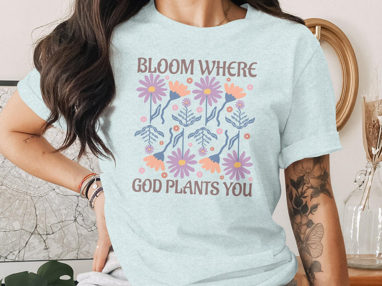 Light blue t-shirt with floral design and text "Bloom Where God Plants You".