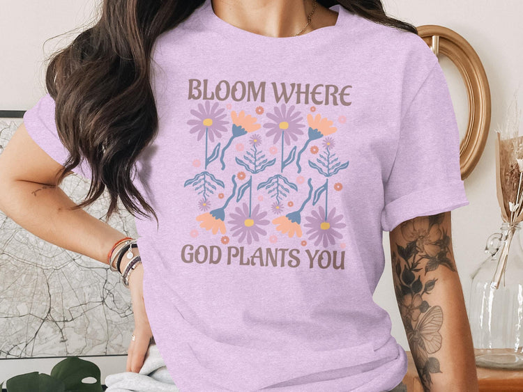 Purple t-shirt with floral design and text "Bloom Where God Plants You".