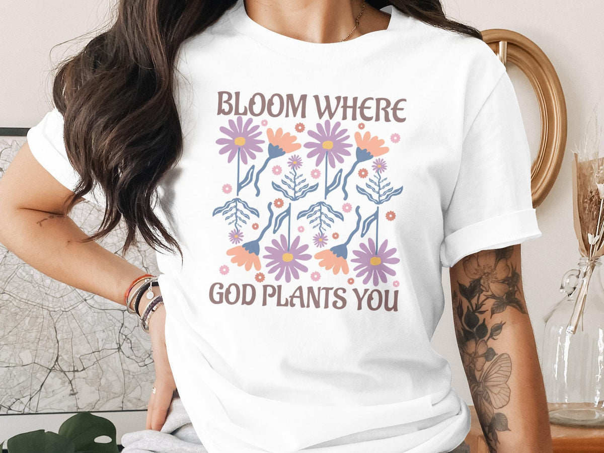 White t-shirt with floral graphic and text "Bloom Where God Plants You".