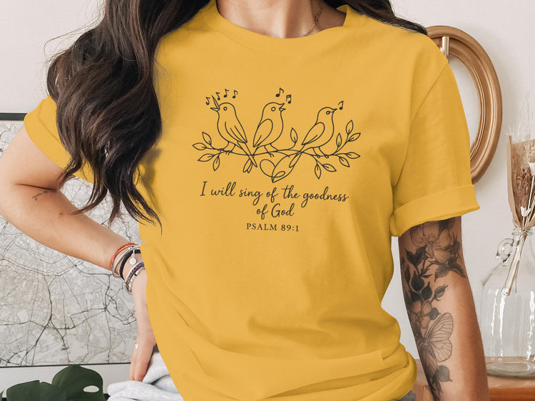 Yellow t-shirt with three birds singing, floral branches, and text "I will sing of the goodness of God PSALM 89:1".