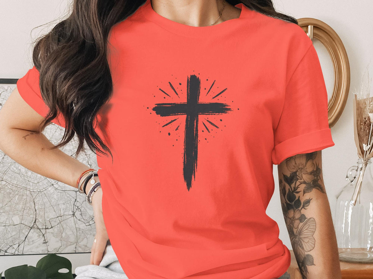 T-shirt with a black distressed cross graphic and sunburst detail.