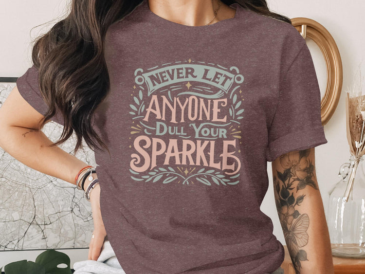 T-shirt with "Never Let Anyone Dull Your Sparkle" text design.