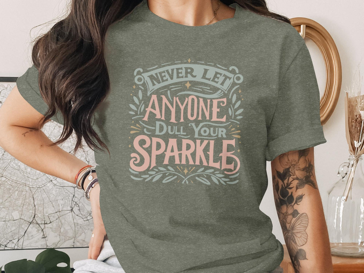 Green t-shirt with "Never Let Anyone Dull Your Sparkle" text design.