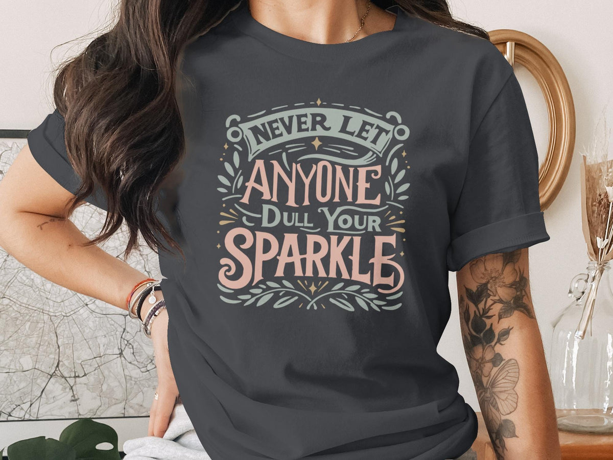 T-shirt with "Never Let Anyone Dull Your Sparkle" text design.