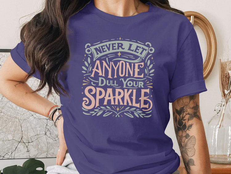 Purple t-shirt with text "Never let anyone dull your sparkle."