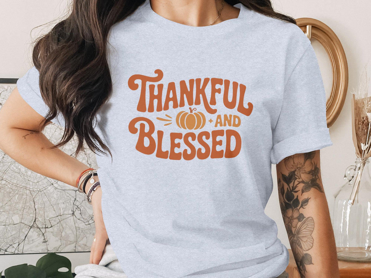 Light grey t-shirt with orange graphic "Thankful and Blessed" and pumpkin.