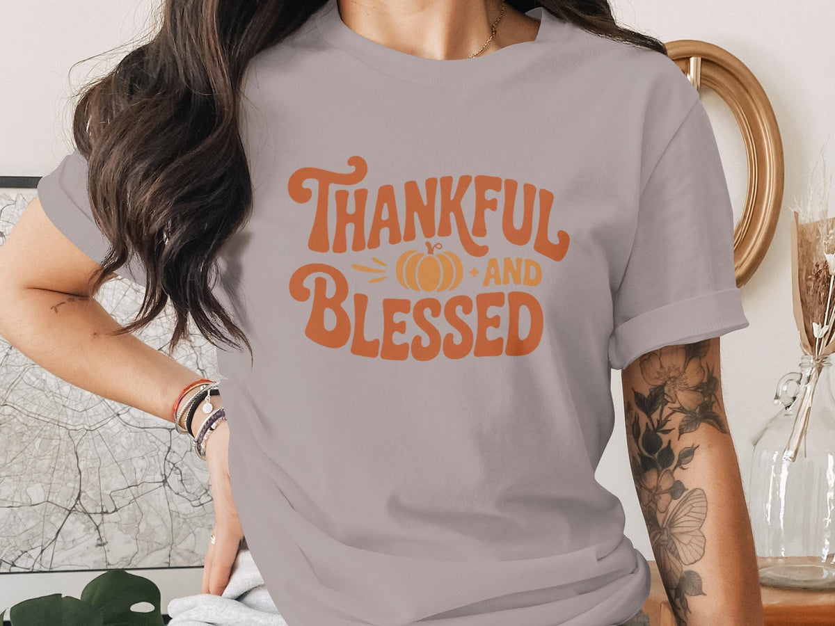 Gray t-shirt with orange text reading "Thankful and Blessed" with a pumpkin.