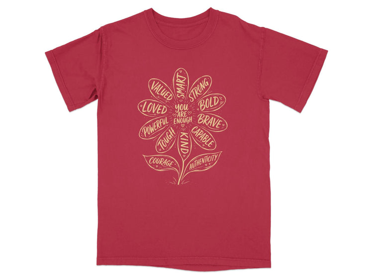 Red t-shirt with a daisy graphic listing positive attributes and "You Are Enough."