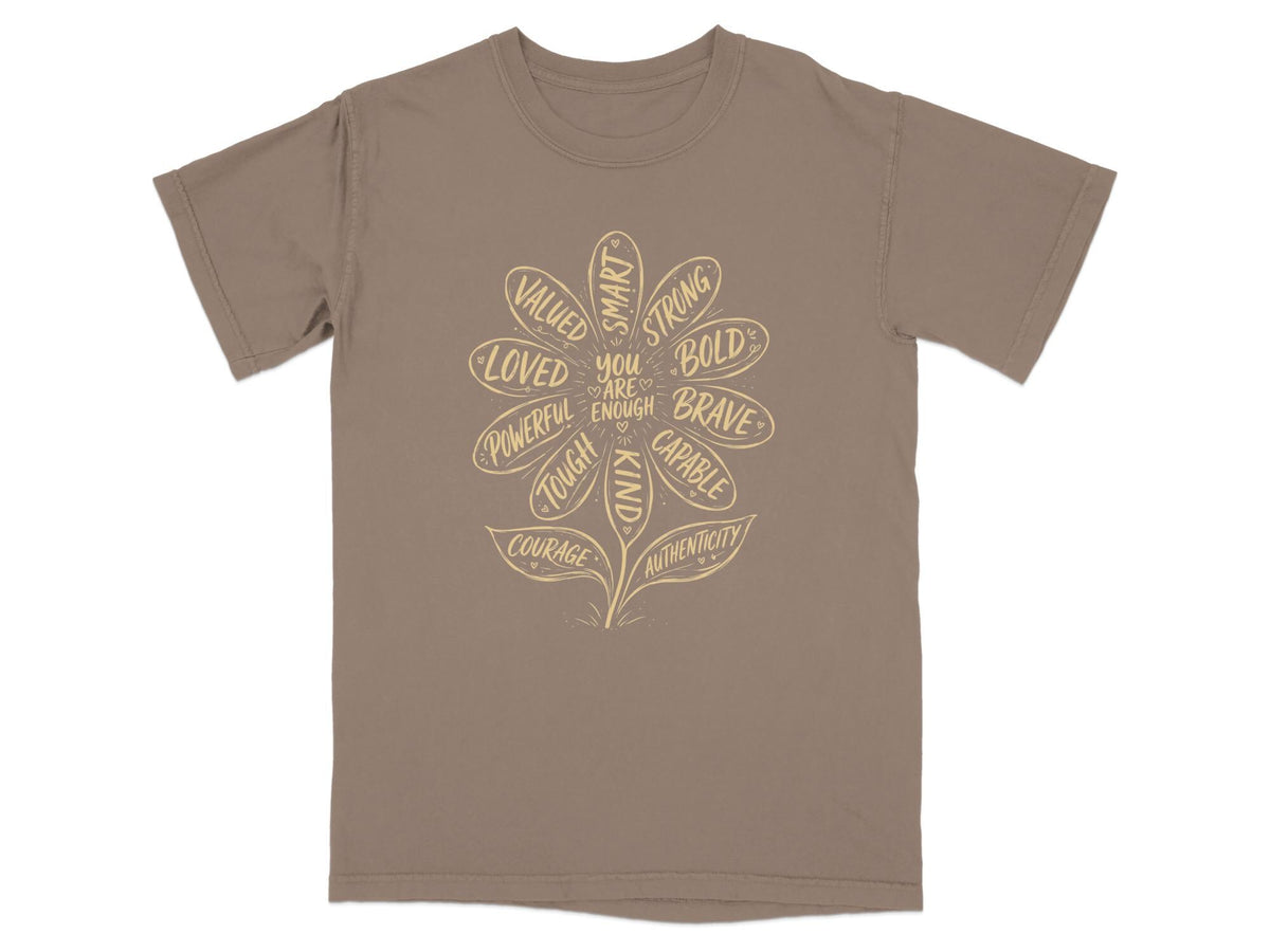 Brown t-shirt with a flower design listing positive affirmation words.