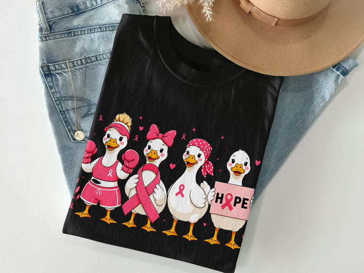 Black t-shirt with four cartoon ducks in pink supporting breast cancer awareness.