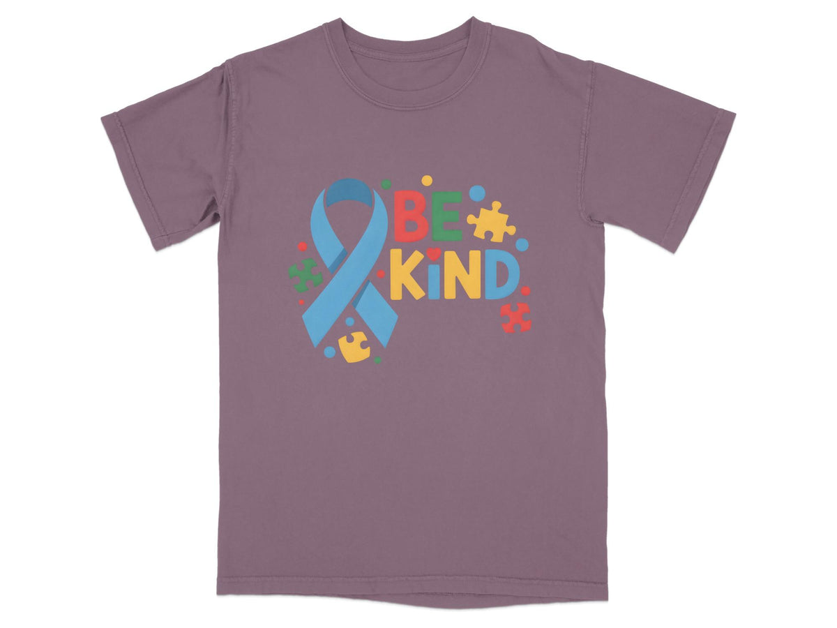 Purple t-shirt with "BE KIND" text, a blue ribbon, and colorful puzzle pieces.